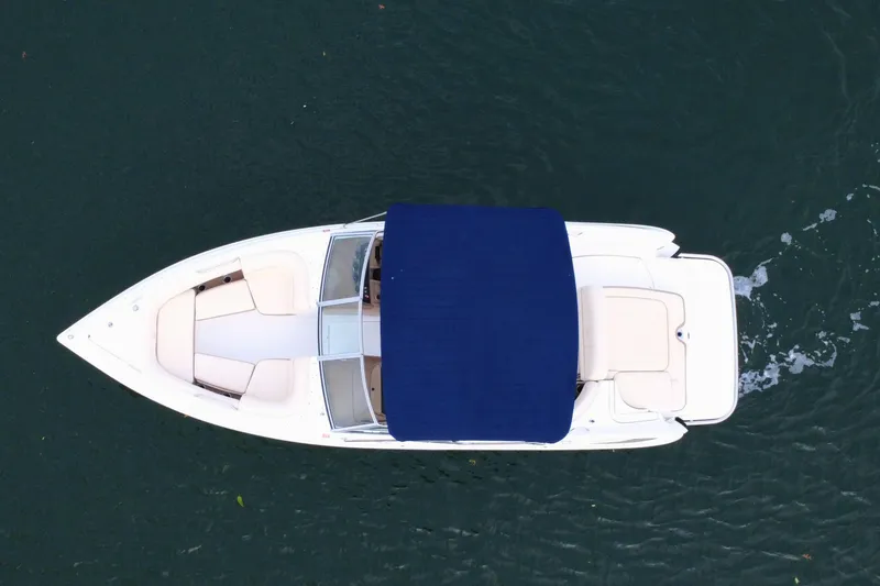 Slide: The Image of Overhead view of a 2010 Cobalt 242 boat with blue canopy on water. - 9