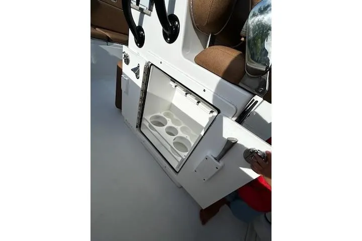 Slide: The Image of 2023 Sea Hunt Ultra 239 SE boat interior with brown seating and white deck. - 10