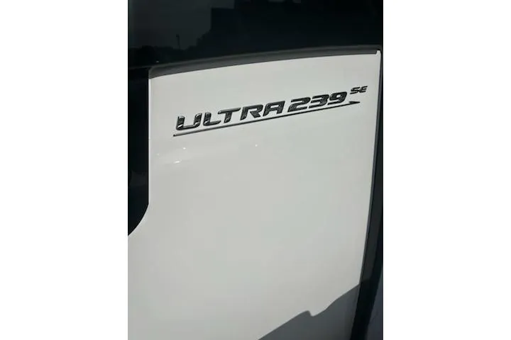 Slide: The Image of 2023 Sea Hunt Ultra 239 SE boat with brown seating and white deck. - 12