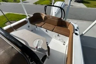 Slide: The Image of 2023 Sea Hunt Ultra 239 SE boat interior with brown seating and white deck. - 14