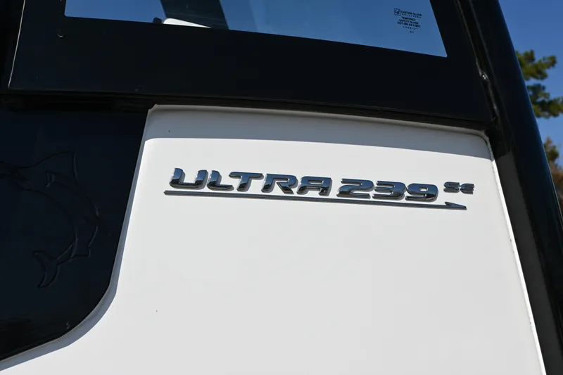 Slide: The Image of 2023 Sea Hunt Ultra 239 SE boat emblem on white surface. - 23