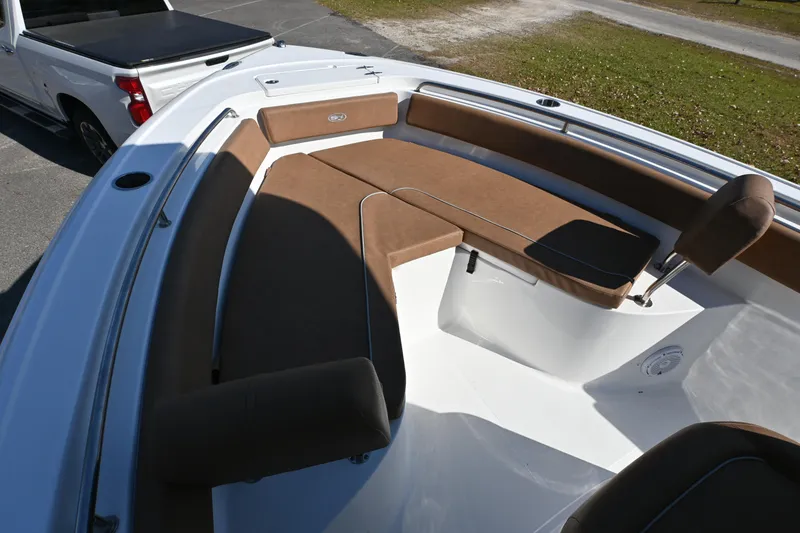 Slide: The Image of 2023 Sea Hunt Ultra 239 SE boat interior with brown cushioned seating. - 26