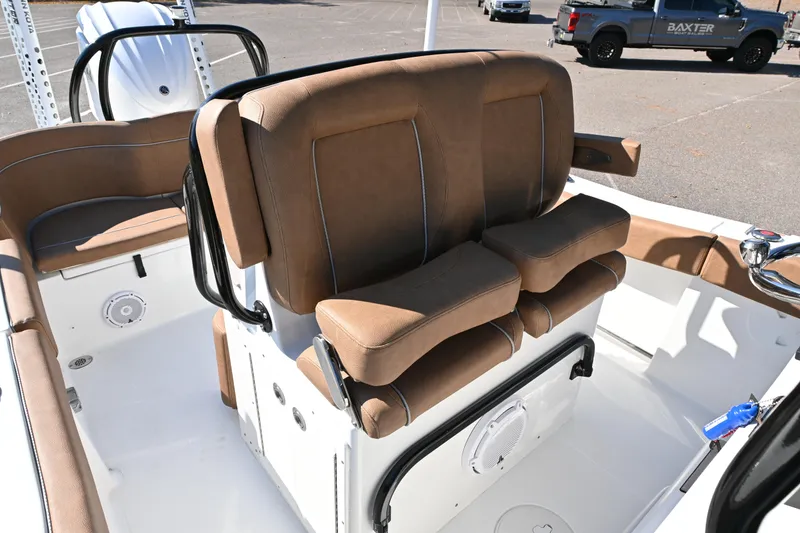 Slide: The Image of 2023 Sea Hunt Ultra 239 SE boat interior with brown cushioned seating. - 28