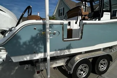 Slide: The Image of 2023 Sea Hunt Ultra 239 SE boat cruising on a scenic lake. - 3