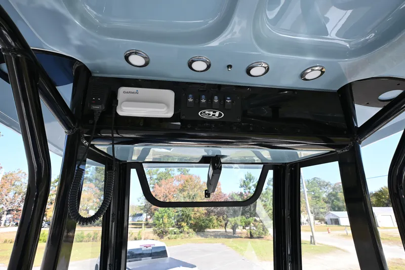 Slide: The Image of 2023 Sea Hunt Ultra 239 SE boat interior with Garmin electronics and overhead lighting. - 30