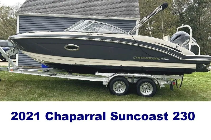 Slide: The Image of 2021 Chaparral 230 Suncoast boat on trailer, parked on grass. - 10