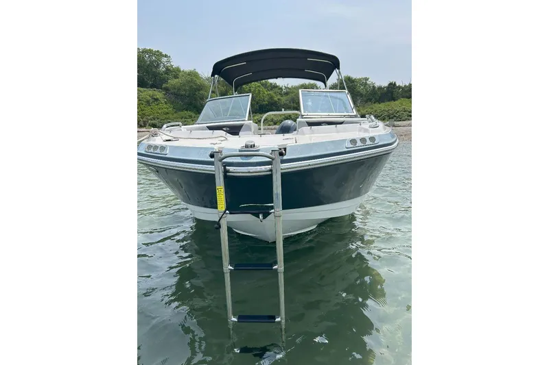 Slide: The Image of 2021 Chaparral 230 Suncoast boat with ladder, anchored in calm water. - 3