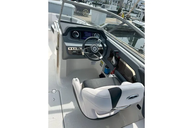 Slide: The Image of 2021 Chaparral 230 Suncoast boat cockpit with steering wheel and controls. - 6
