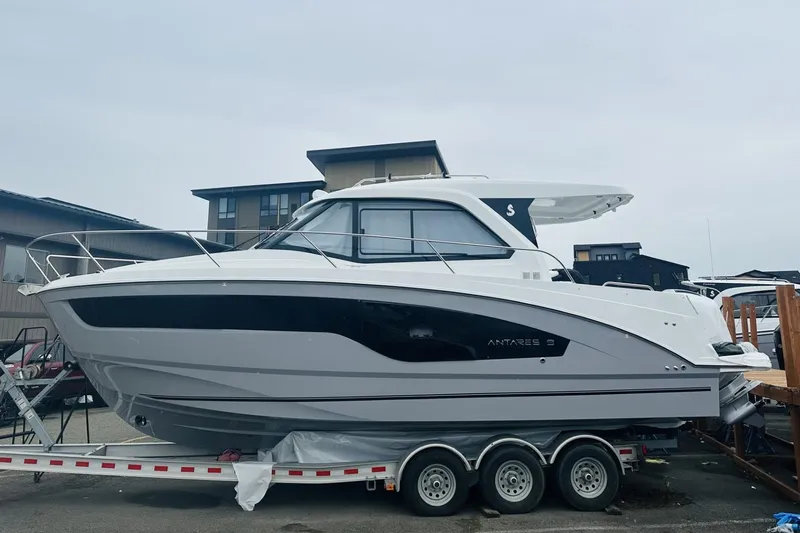 Slide: The Image of 2026 Beneteau Antares 9 V2 boat on trailer, sleek design, dockside view. - 2
