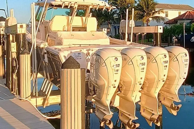 Slide: The Image of 2025 Grady-White Canyon 456 boat docked with four powerful outboard engines. - 3