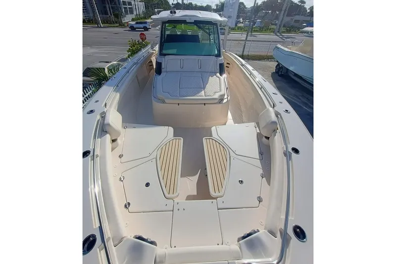 Slide: The Image of 2025 Grady-White Canyon 456 boat, spacious deck, modern design, docked outdoors. - 4