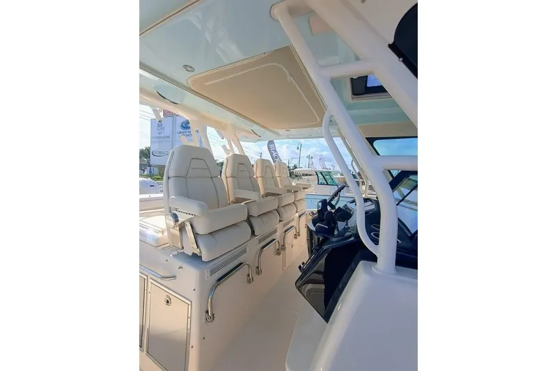 Slide: The Image of 2025 Grady-White Canyon 456 boat interior with luxurious seating and modern design. - 5