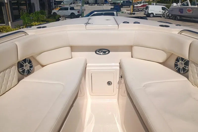 Slide: The Image of 2025 Grady-White Canyon 456 boat interior with cushioned seating and speakers. - 13