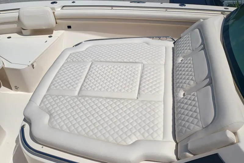 Slide: The Image of Luxurious seating on 2025 Grady-White Canyon 456 boat, featuring diamond-stitched upholstery. - 20