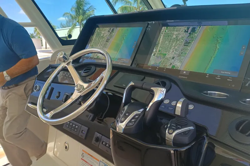 Slide: The Image of 2025 Grady-White Canyon 456 helm with dual Garmin displays and advanced controls. - 26