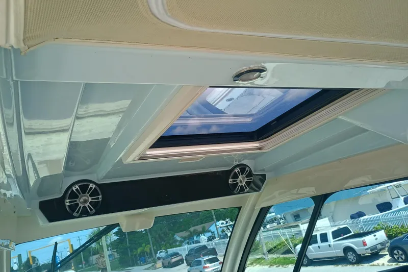 Slide: The Image of Interior view of 2025 Grady-White Canyon 456 boat with sunroof and speakers. - 27