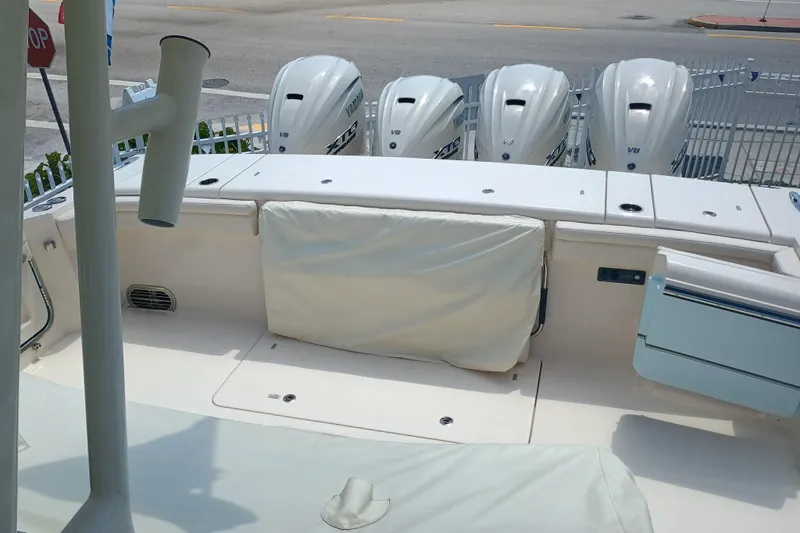 Slide: The Image of 2025 Grady-White Canyon 456 boat with four Yamaha V8 engines, docked at marina. - 28