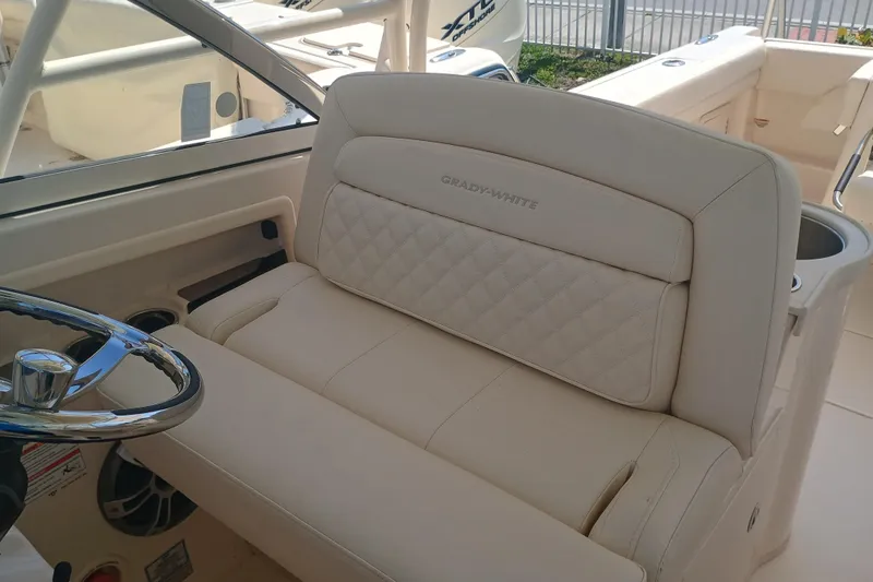 Slide: The Image of 2025 Grady-White Canyon 456 boat interior with luxurious seating and steering wheel. - 3