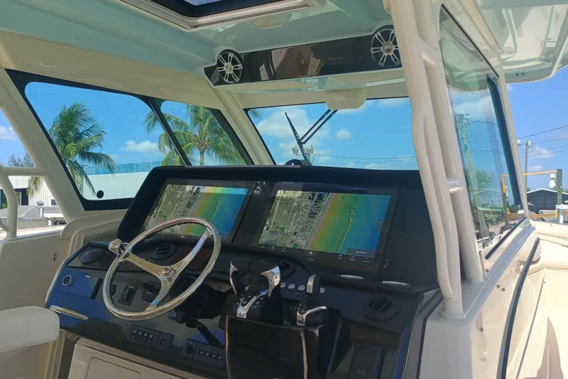 Slide: The Image of 2025 Grady-White Canyon 456 helm with dual navigation screens and modern controls. - 32