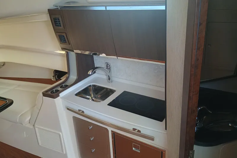 Slide: The Image of 2025 Grady-White Canyon 456 boat interior with kitchenette and modern amenities. - 34