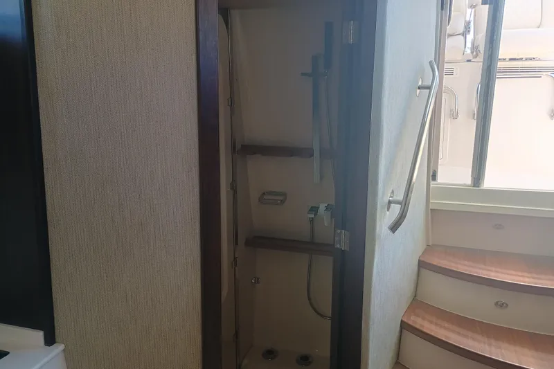 Slide: The Image of Interior view of 2025 Grady-White Canyon 456 boat, featuring a compact shower area. - 41