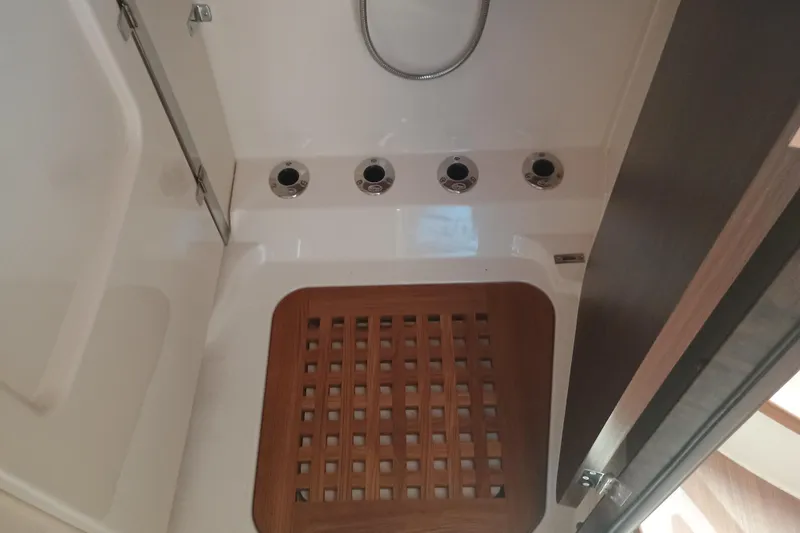 Slide: The Image of Grady-White Canyon 456 2025 boat interior with wooden flooring and drainage system. - 44