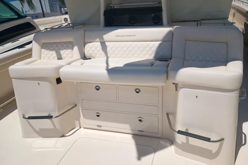 Slide: The Image of Luxurious seating on 2025 Grady-White Canyon 456 boat, featuring quilted upholstery and storage compartments. - 46