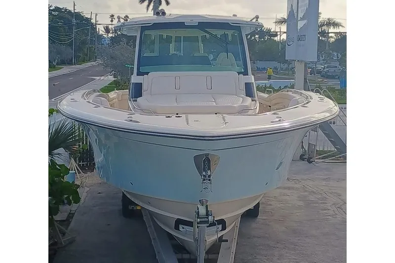 Slide: The Image of 2025 Grady-White Canyon 456 boat on trailer, parked near a road. - 49