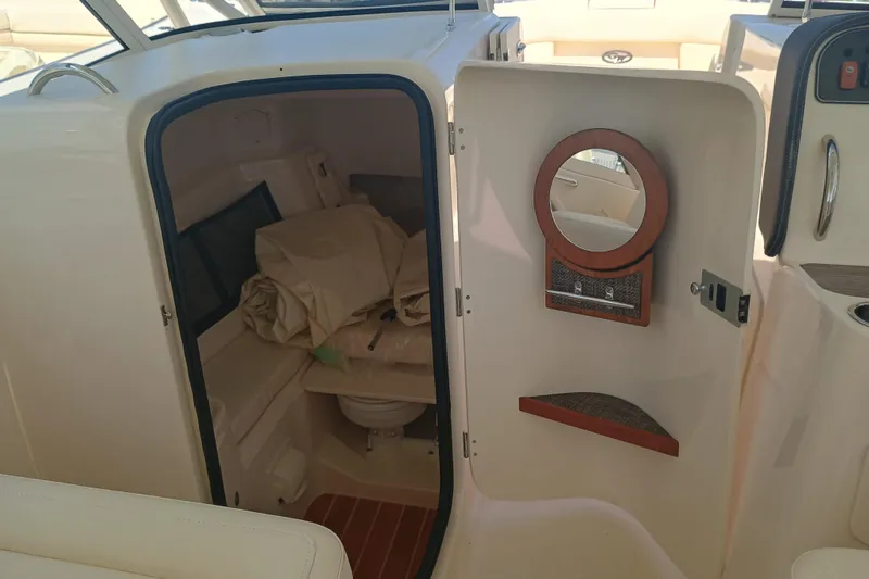 Slide: The Image of 2025 Grady-White Canyon 456 boat interior with compact cabin and mirror. - 7