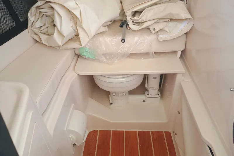 Slide: The Image of Interior of 2025 Grady-White Canyon 456 boat featuring compact marine toilet. - 9