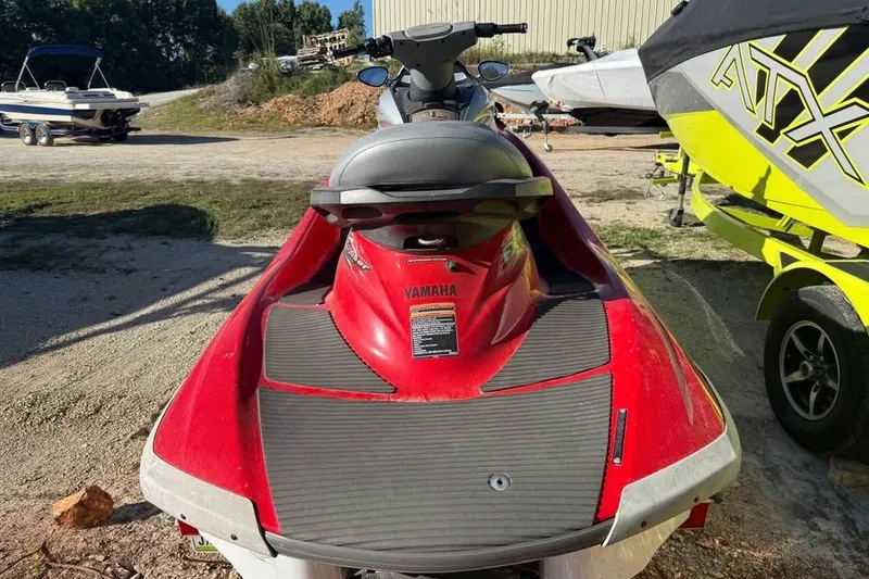 Slide: The Image of 2005 Yamaha WaveRunner FX Cruiser HO in red, parked outdoors near other boats. - 2