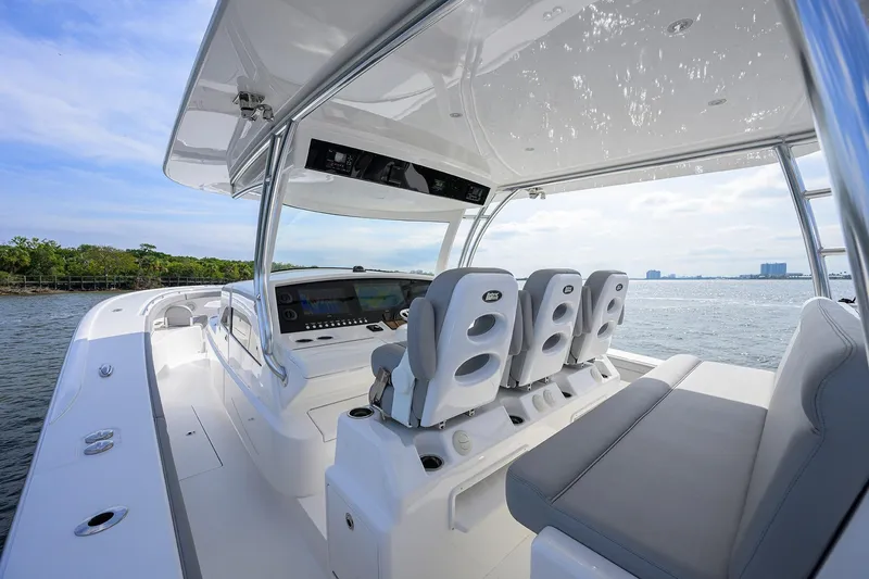 Slide: The Image of 2024 Valhalla Boatworks V-46 interior with modern helm and seating on open water. - 13
