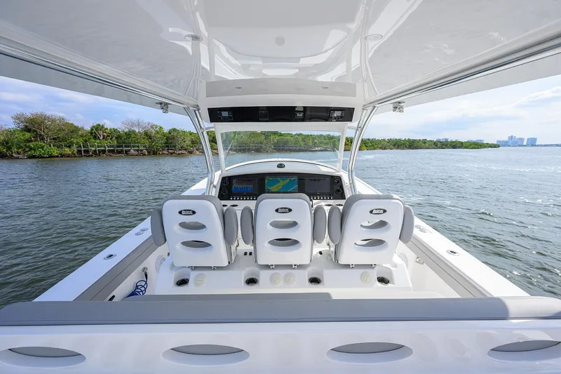 Slide: The Image of 2024 Valhalla Boatworks V-46 cockpit with modern seating and navigation system on open water. - 19