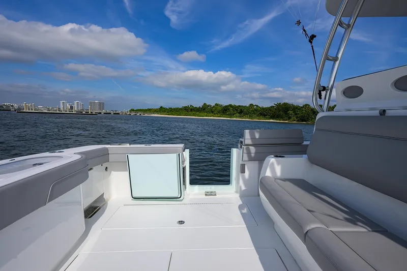 Slide: The Image of 2024 Valhalla Boatworks V-46, luxury deck view, coastal skyline, clear blue sky. - 40