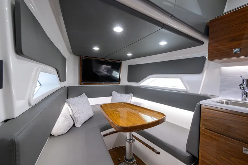 Slide: The Image of Luxurious interior of 2024 Valhalla Boatworks V-46 with modern seating and wooden table. - 47