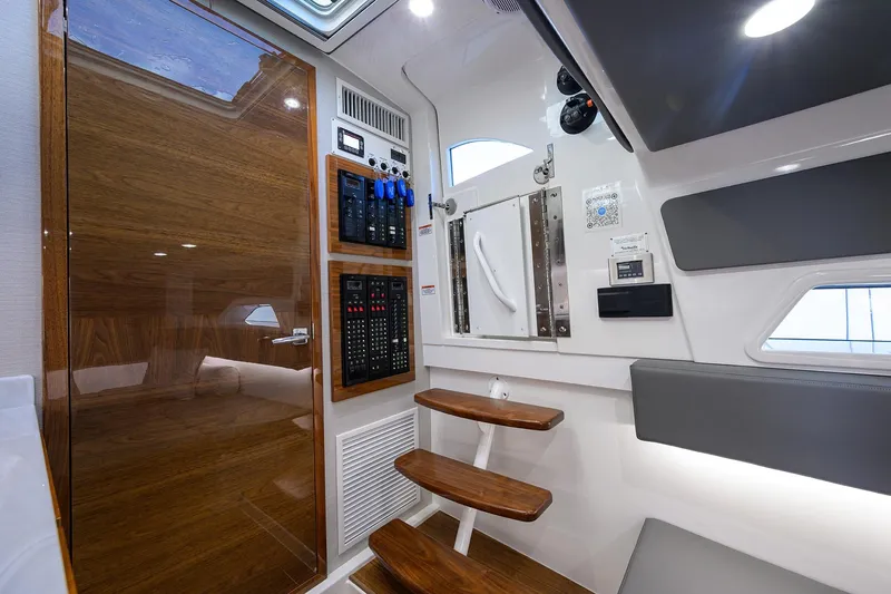 Slide: The Image of 2024 Valhalla Boatworks V-46 interior with wooden accents and modern control panels. - 50