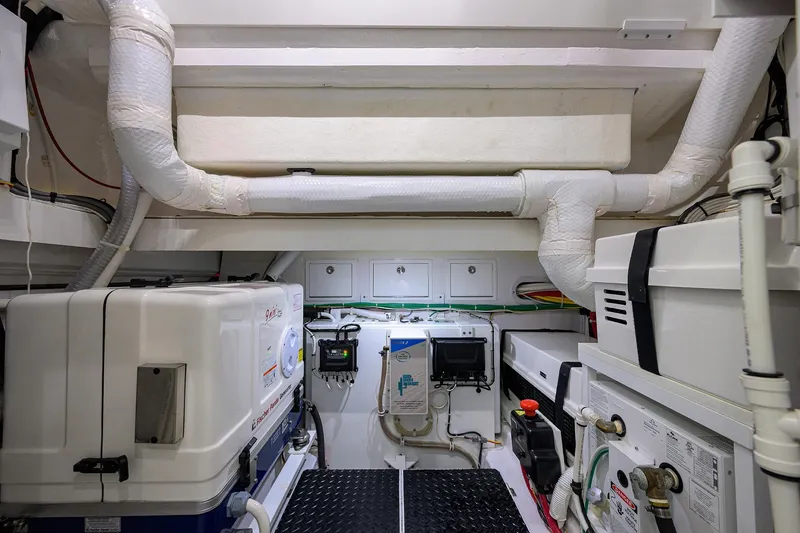 Slide: The Image of Engine room of 2024 Valhalla Boatworks V-46, showcasing equipment and piping. - 54