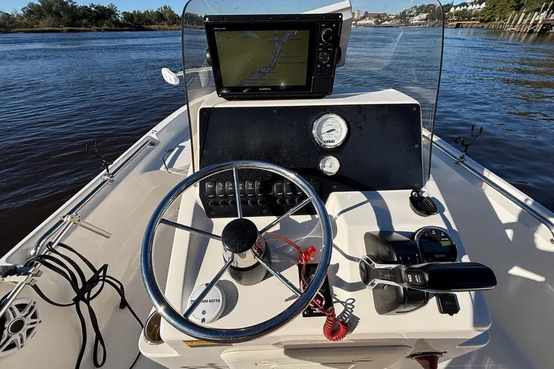 Slide: The Image of Bulls Bay 2000 boat dashboard with steering wheel and navigation system, 2022 model. - 12