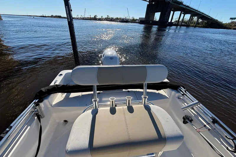 Slide: The Image of 2022 Bulls Bay 2000 boat on water near a bridge, featuring a comfortable seating area. - 13