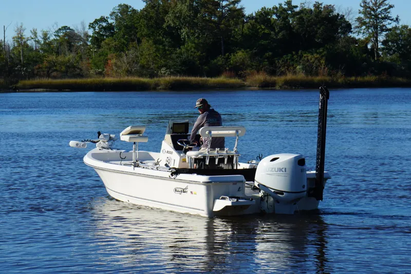Slide: The Image of Bulls Bay 2000 boat on a serene lake, 2022 model, with Suzuki outboard motor. - 6