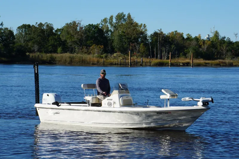 Slide: The Image of 2022 Bulls Bay 2000 boat on a calm river with a person onboard. - 8