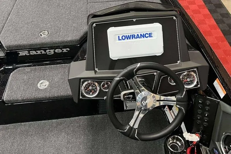 Slide: The Image of 2026 Ranger Z518 Cup-Equipped boat dashboard with Lowrance display and steering wheel. - 3