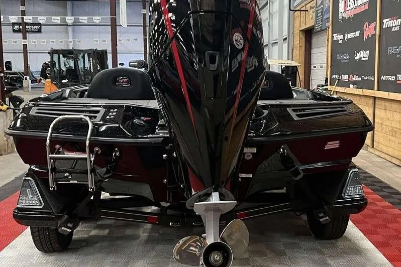 Slide: The Image of 2026 Ranger Z518 Cup-Equipped boat in showroom, rear view with motor and ladder. - 6