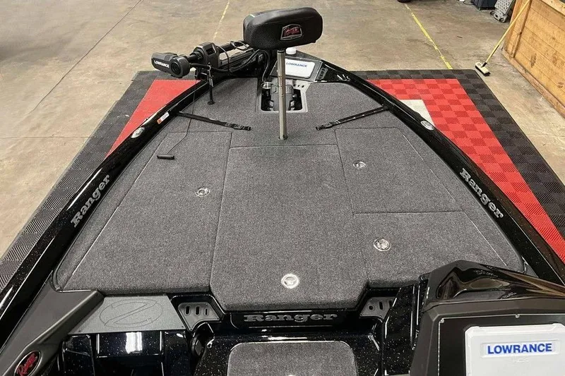 Slide: The Image of 2026 Ranger Z518 Cup-Equipped boat deck with Lowrance electronics and carpeted surface. - 7