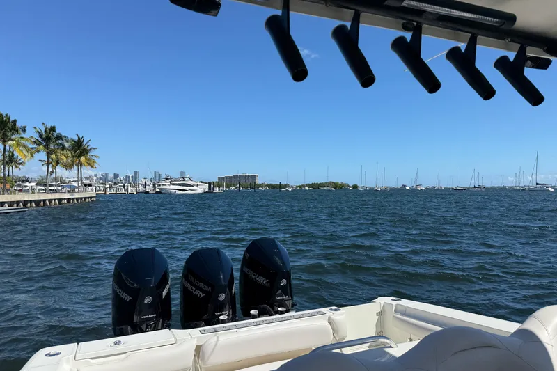Slide: The Image of 2003 Hydra-Sports Vector 3300 CC on water, with Mercury engines, city skyline in background. - 11