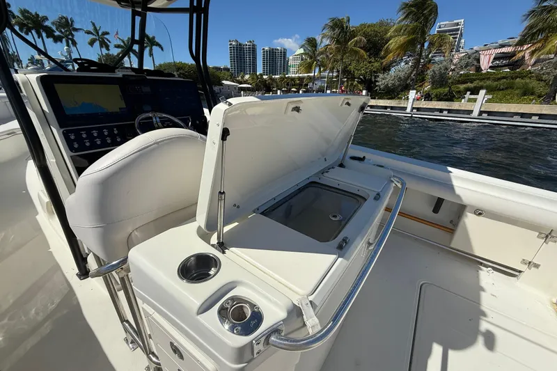 Slide: The Image of 2003 Hydra-Sports Vector 3300 CC boat interior with open storage compartment, dockside view. - 13