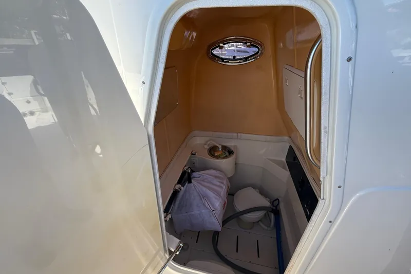 Slide: The Image of 2003 Hydra-Sports Vector 3300 CC boat cabin interior with toilet and storage. - 16