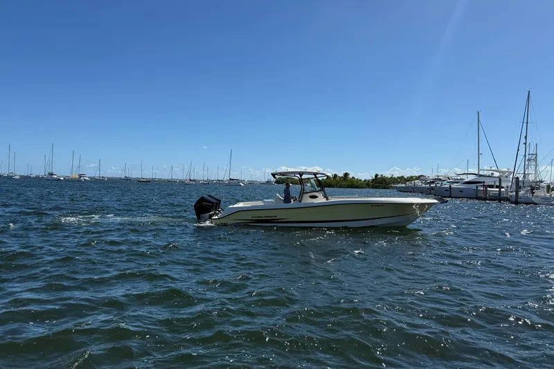 Slide: The Image of 2003 Hydra-Sports Vector 3300 CC boat cruising on a sunny day in a marina. - 2