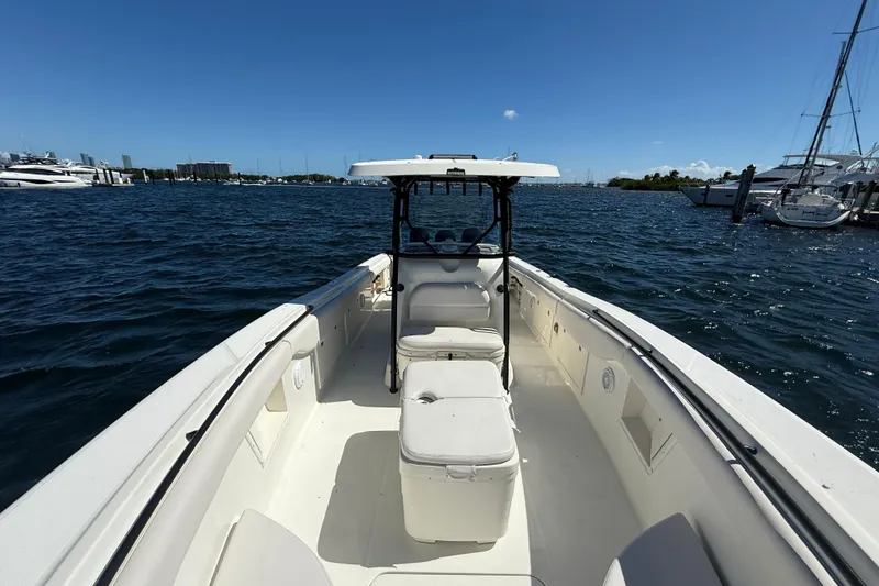 Slide: The Image of 2003 Hydra-Sports Vector 3300 CC boat on water, clear sky, marina background. - 20