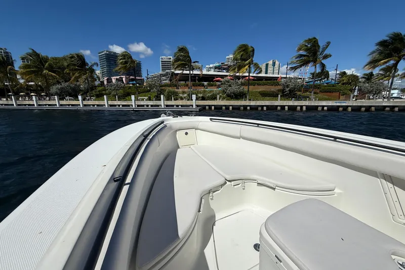 Slide: The Image of 2003 Hydra-Sports Vector 3300 CC boat near waterfront with palm trees and buildings. - 23